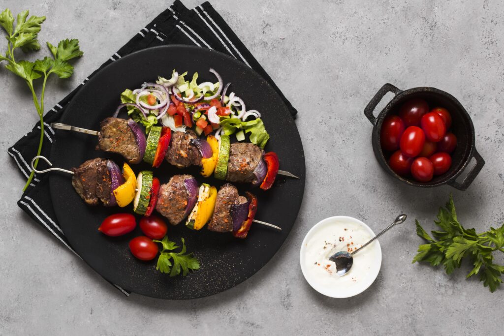 delicious-arabic-fast-food-skewers-black-plate-tomatoes